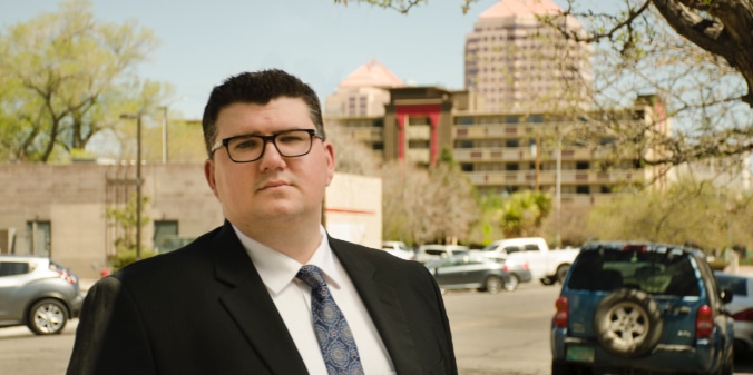 Nicholas Hart standing outside in suit on sunny day